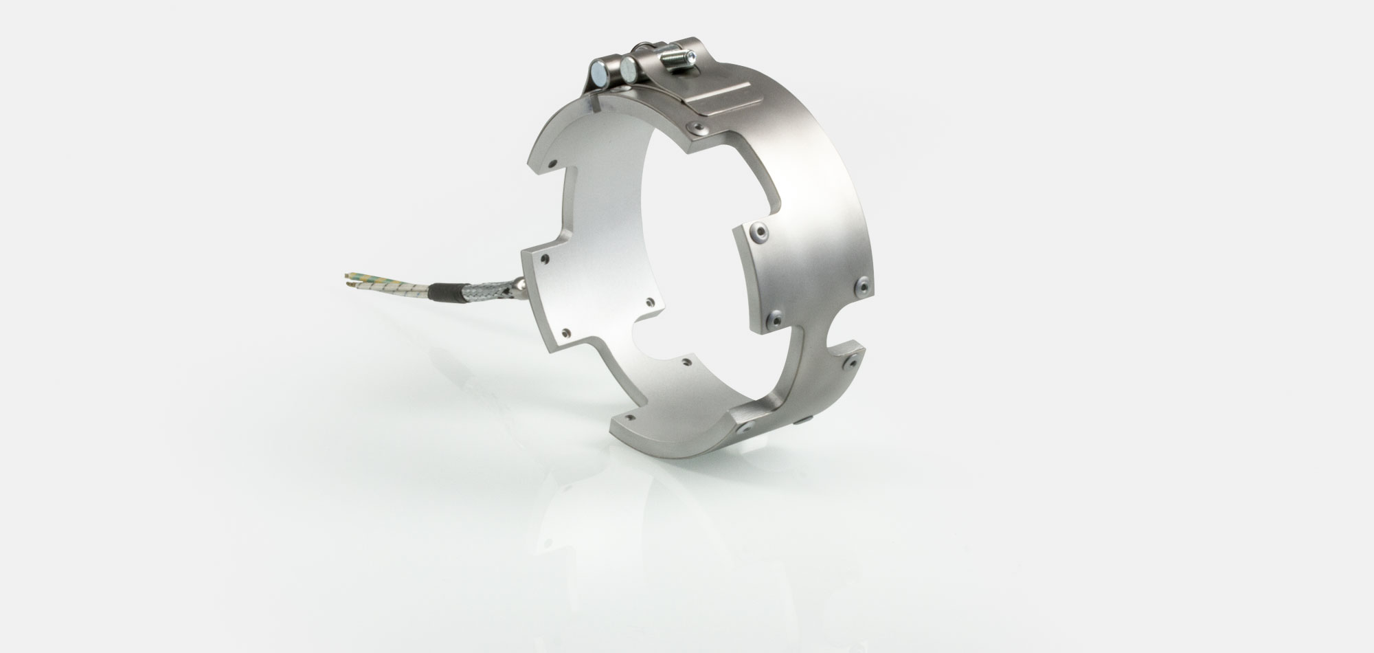 Düsenheizband, für Temperatur bis 450°C/550°C, Spitzguss, energieeffiziente Ausführung, homogener Wärmeverlauf, Bohrungen, Aussparungen, Wärmefühlerhaltung, integriertes Thermoelement, Sonderkontur, enge Einbauverhältnisse, Kabelextrusion