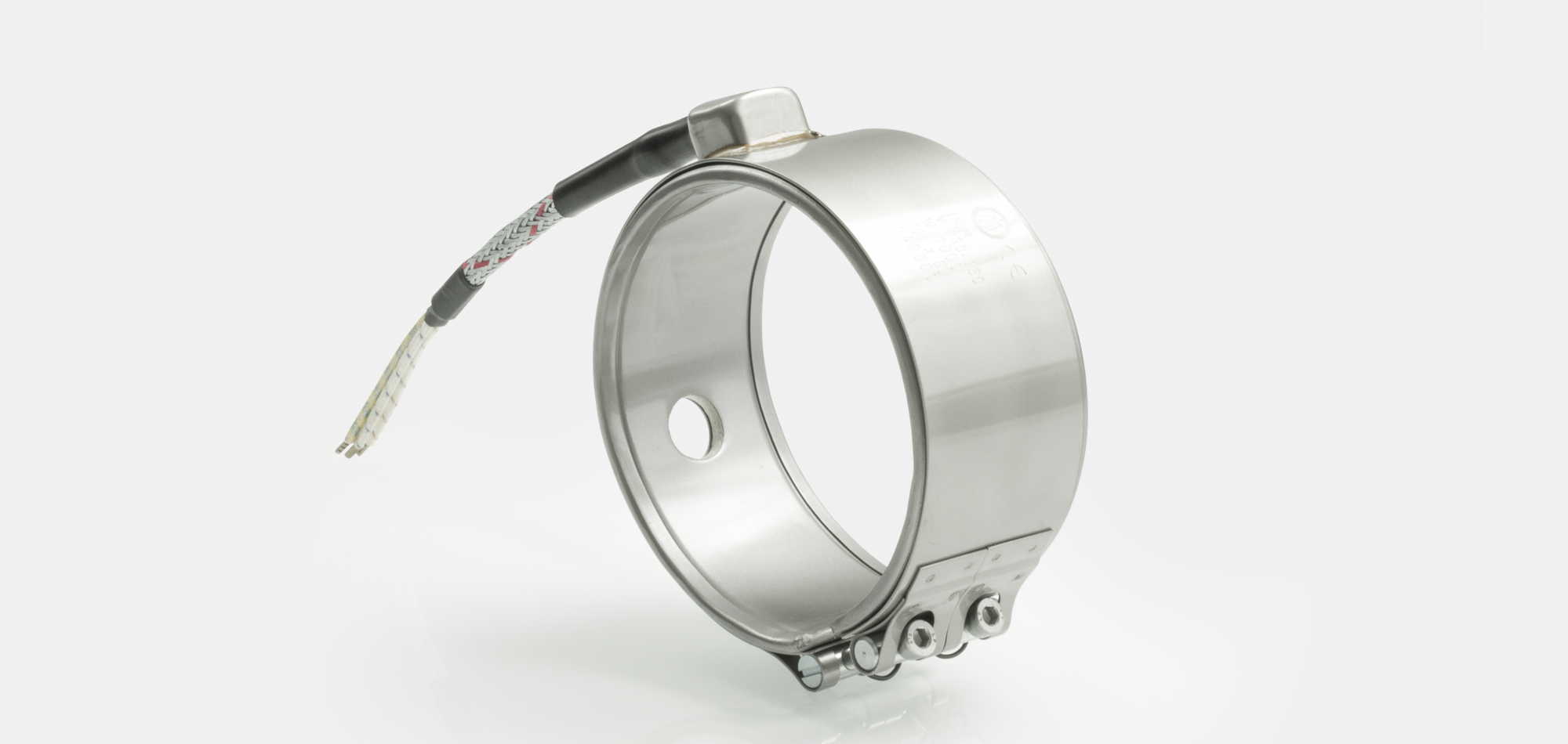 Hochleistungs-Düsenheizband, Temperatur bis 600°C, Spitzguss, Bohrungen, Aussparungen, Wärmefühlerhaltung, integriertes Thermoelement, enge Einbauverhältnisse, anspruchsvolle Materialien,  PTFE-PEEK Verarbeitung, verringerte Zykluszeiten, Kabelextrusion